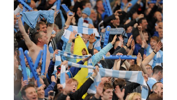 Manchester City fans celebrate their 1-0 victory amid jubilant scenes