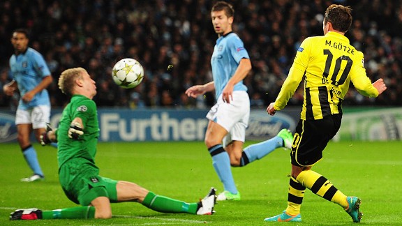 Manchester City goalkeeper Joe Hart blocks the shot of Mario Gotze of Borussia Dortmund