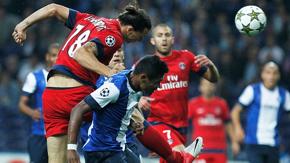 Paris Saint Germain's Zlatan Ibrahimovic heads the ball past Porto's Alex Sandro