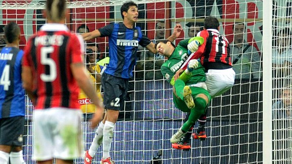 Inter goalkeeper Samir Handanovic is clattered after saving an attempt on goal from Gianpaolo Pazzini