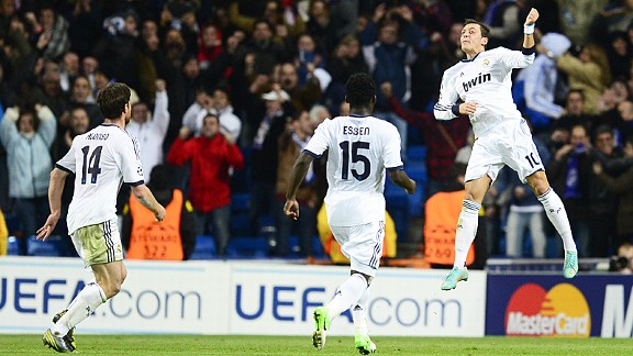 Mesut Ozil leaps in the air after scoring the goal which ensured Real Madrid avoided a home defeat at the hands of Borussia Dortmund