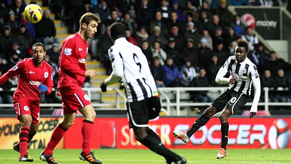 Gael Bigirimana watches his stunning effort head towards the Wigan net