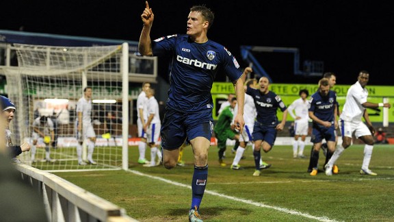 Matt Smith celebrates his injury-time equaliser for Oldham