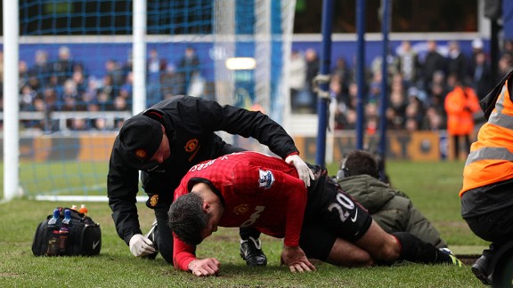 Robin van Persie receives treatment on an injury against QPR
