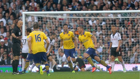Arsenal celebrate after taking a 2-0 lead at Fulham through Lukas Podolski.