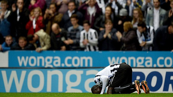 Papiss Cisse kisses the turf after giving Newcastle the lead against Leeds.