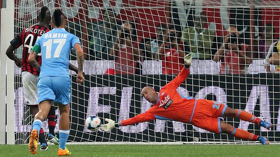 Napoli keeper Pepe Reina saves a penalty by AC Milan's Mario Balotelli.