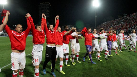 Switzerland players celebrate securing their place in Brazil.