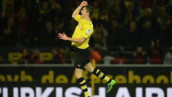 Robert Lewandowski jumps for joy after scoring against Stuttgart.