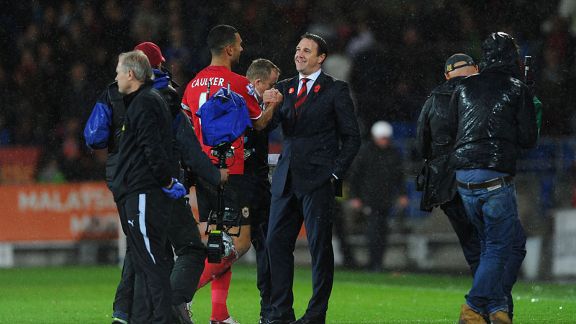 Malky Mackay celebrates Cardiff's win against Swansea with Steven Caulker.