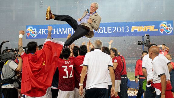 Marcello Lippi is lofted into the air after guiding Guangzhou Evergrande to the Asian Champions League title.