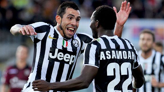 Carlos Tevez celebrates with Kwadwo Asamoah after wrapping up the victory.