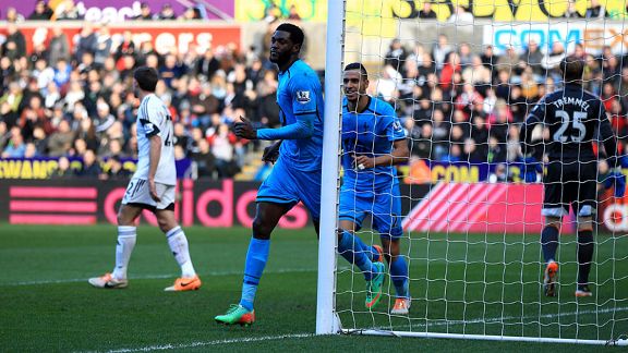 Emmanuel Adebayor celebrates after breaking the deadlock at Swansea.