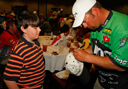Fred Roumbanis signs an autograph for one of his fans, John Moore.