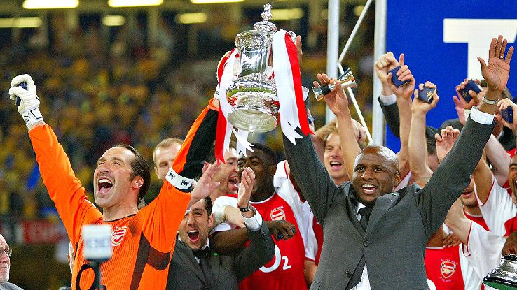 David Seaman, left, lifts the FA Cup trophy alongside Patrick Vieira in 2003.