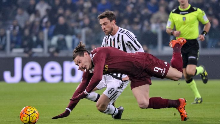 JUVENTUS STADIUM, TURIN, ITALY - 2015/12/16: Andrea Belotti (left) and Claudio Marchisio (right) fight for the ball during the Italy Cup match between Juventus FC and Torino FC. Juventus FC wins 4-0 over Torino FC. 