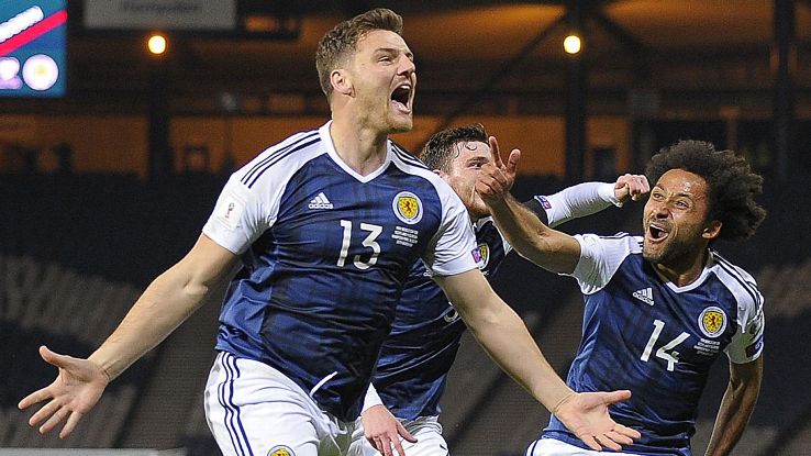 Chris Martin, left, celebrates after scoring a dramatic winner for Scotland against Slovenia.