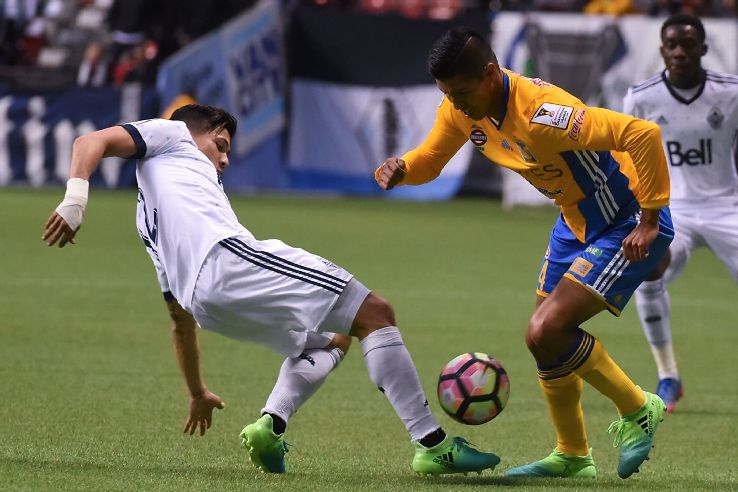 Vancouver Whitecaps' Fredy Montero, left, reaches for the ball against Hugo Ayala of Tigres.
