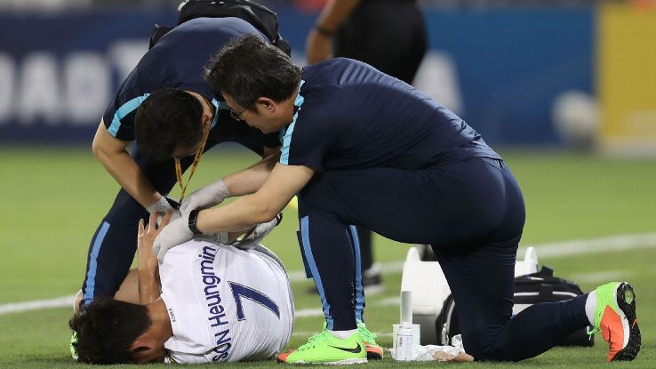 Son Heung-Min receives medical treatment during South Korea's World Cup qualifying match against Qatar.