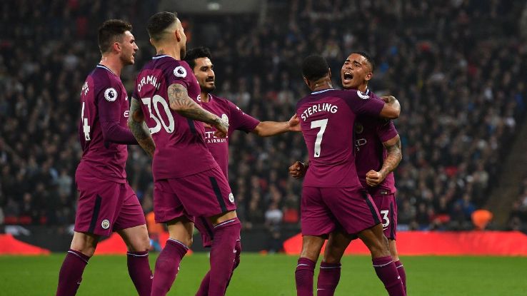 Man City celebrate their third goal against Tottenham.