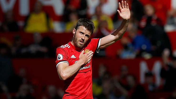 Manchester United's Michael Carrick salutes the fans as he leaves the field.