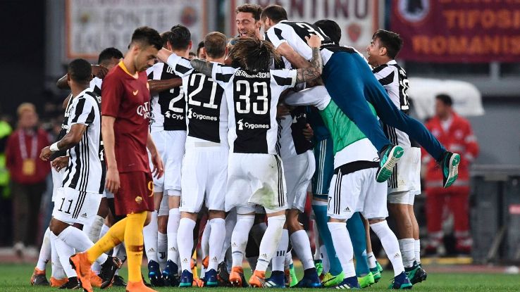 Juventus players celebrate after a 0-0 draw with Roma that secured the Serie A title for a seventh-straight season.