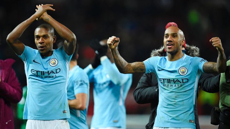 Fernandino, left, and Fabian Delph celebrate Manchester City's win over Manchester United.