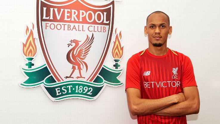 Fabinho poses for a photo after signing for Liverpool.