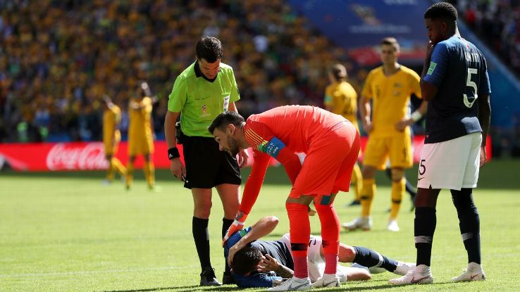 France's Lucas Hernandez is checked on by teammates Hugo Lloris and Samuel Umtiti.