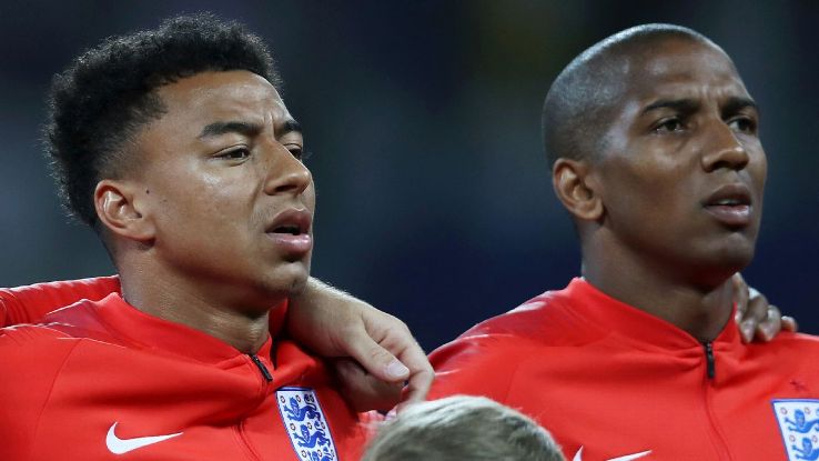 Jesse Lingard and Ashley Young stand for the anthems prior to England's World Cup group-stage win over Tunisia.