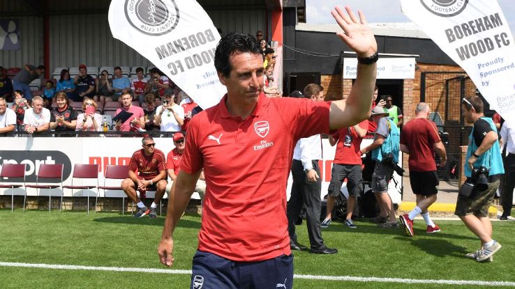 Unai Emery waves to fans before Arsenal's preseason friendly at Boreham Wood.