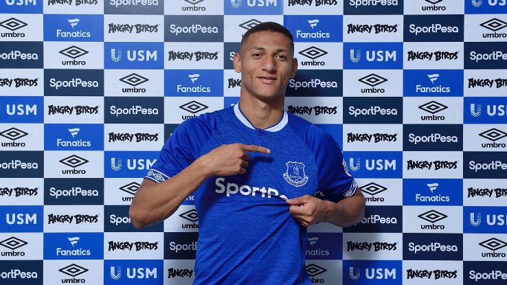 Richarlison poses for photos after signing for Everton.