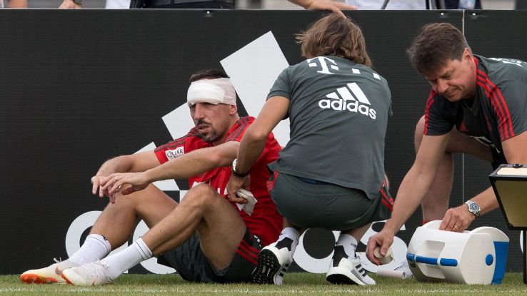   Bayern Munich's Franck Ribery is treated by medical staff after colliding with a goal post. 