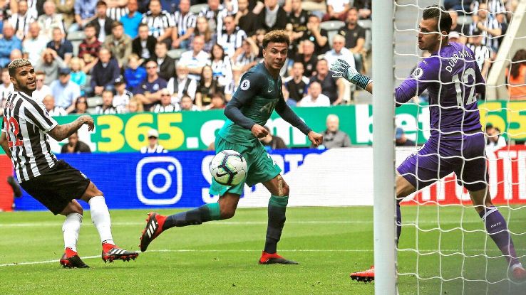 Dele Alli (C) watches the ball into the net after scoring his team's second goal at Newcastle.
