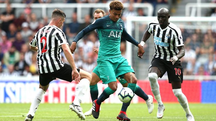 Tottenham Hotspur's Dele Alli is challenged by Newcastle United's Ciaran Clark, left, and Mohamed Diame.