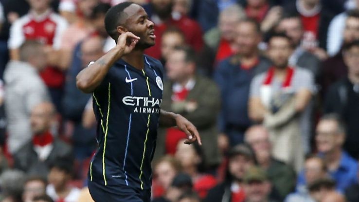 Raheem Sterling celebrates after scoring Man City's opener against Arsenal.