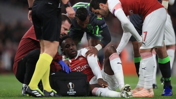 Danny Welbeck is injured in Arsenal's Europa League match against Sporting.