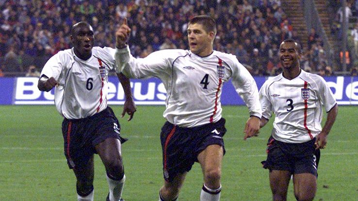 England's Steven Gerrard, centre, celbartes his 2-1 goal  during a World Cup 2002 qualifying match of Group 9 Germany vs England in the Olympic stadium of Munich, southern Germany, on Saturday,  Sept. 1, 2001. Left team mate Sol Campbell, right, Ashley Co