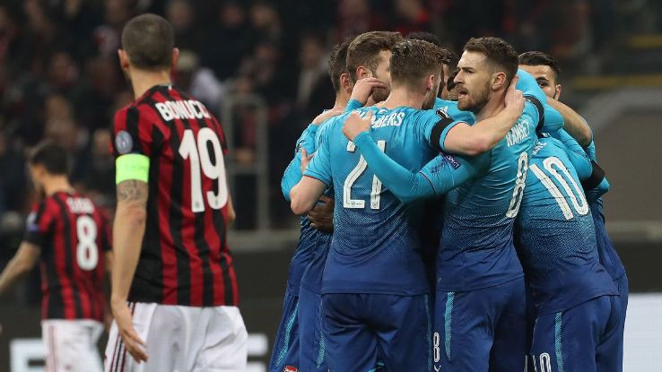 Arsenal celebrate their second goal against AC Milan.