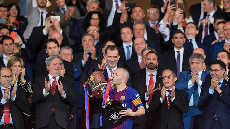 Andres Iniesta kisses the Copa del Rey trophy after Barcelona's 5-0 win over Sevilla. Andres Iniesta kisses the Copa del Rey trophy after Barcelona's 5-0 win over Sevilla.