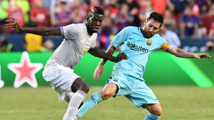 Barcelona's Lionel Messi, right, vies for the ball with Manchester United's Paul Pogba, left.