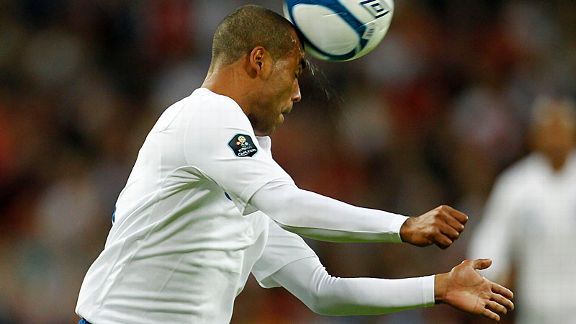 England's Ashley Cole sweats as he heads the ball clear
