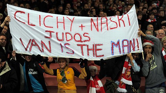 Arsenal fans hold up a banner berratting former players Clichy and Nasri