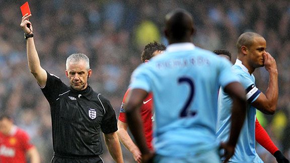 Chris Foy gives Vincent Kompany (r) his marching orders for a two-footed tackle on Nani.