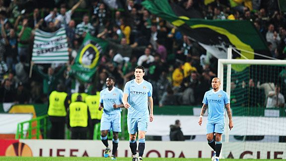Man City players trudge back to the centre circle as Sporting players celebrate Xandao's goal.