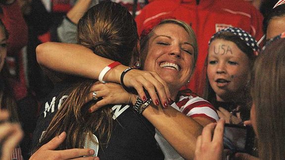 Alex Morgan celebrates with friends in the crowd 