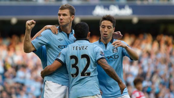 Edin Dzeko celebrates with his team-mates after putting Manchester City into a 2-1 lead