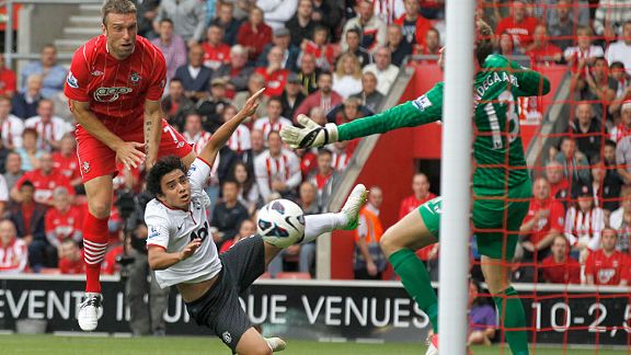 Southampton's Rickie Lambert, left, jumps above Manchester United's Rafael to score