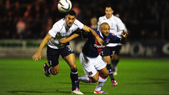 Carlisle striker Danny Cadamarteri tussles for the ball with Steven Caulker of Spurs
