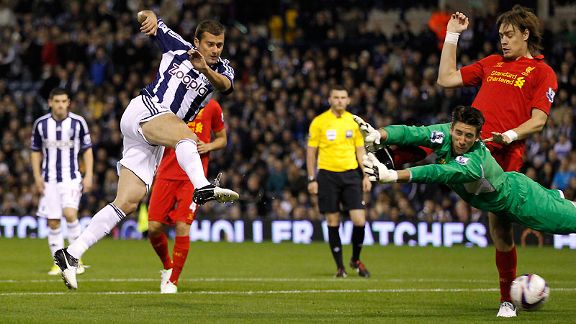 Gabriel Tamas scores past Liverpool goalkeeper Brad Jones